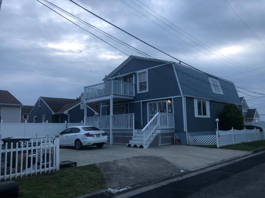 a view of a big house with a yard