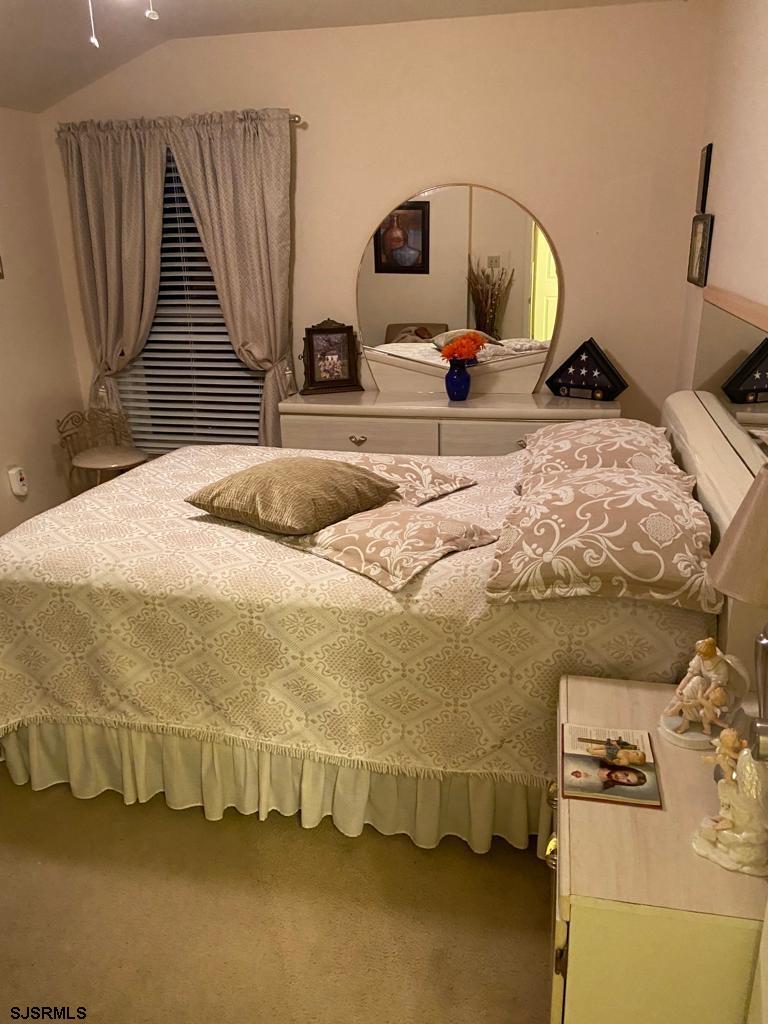 730 Warrena Road Atlantic City, NJ 08401 - Photo 9 of 17 a bedroom with a bed and a large mirror