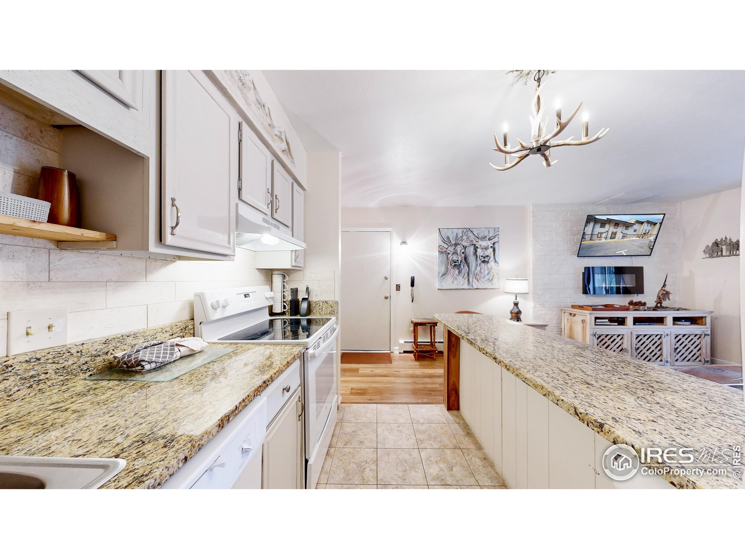 2760 Fall River Road, Unit 288 Estes Park, CO 80517 - Photo 11 of 32 a kitchen with stainless steel appliances granite countertop a sink stove and refrigerator