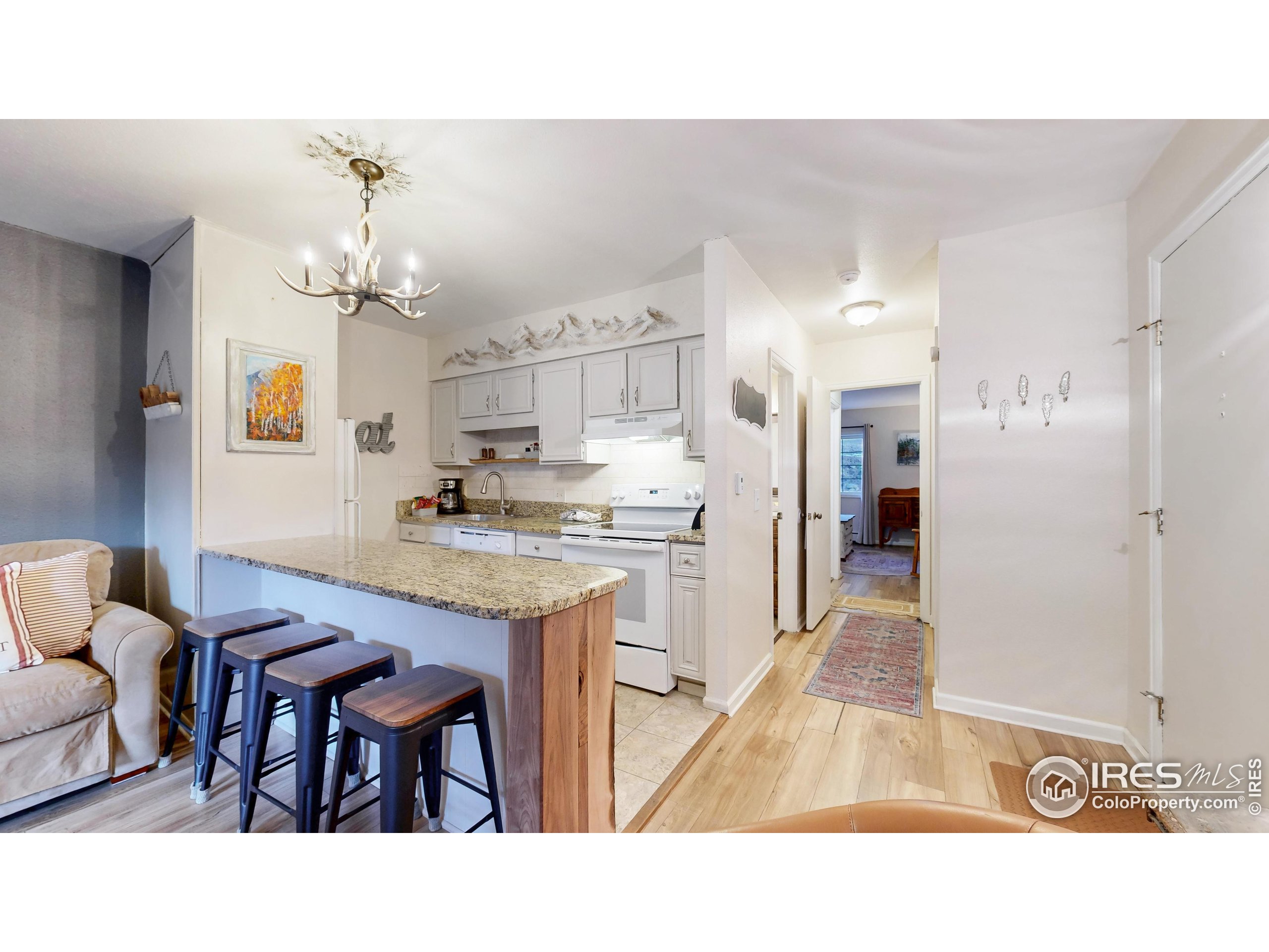 2760 Fall River Road, Unit 288 Estes Park, CO 80517 - Photo 3 of 32 a open kitchen with granite countertop a sink cabinets and refrigerator
