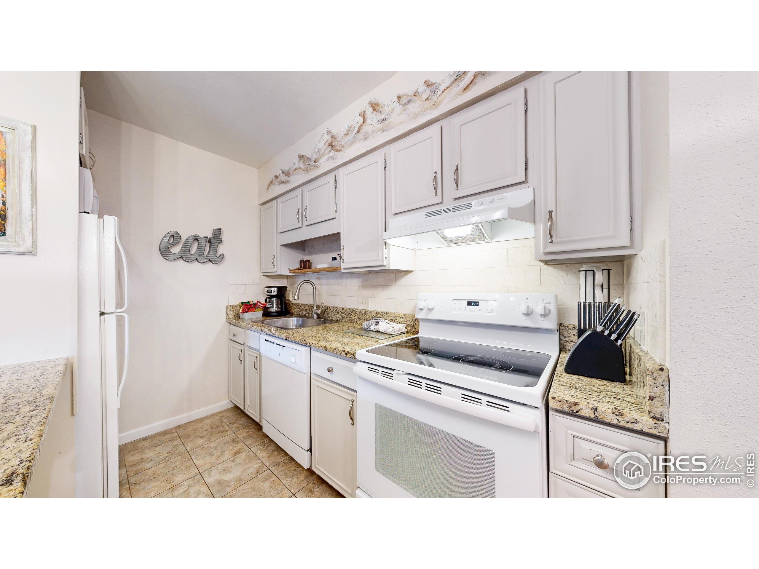 2760 Fall River Road, Unit 288 Estes Park, CO 80517 - Photo 4 of 32 a kitchen with stainless steel appliances granite countertop a sink stove and cabinets