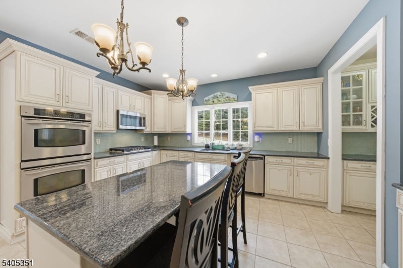 20 Sleepy Hollow Road Denville, NJ 07834 - Photo 14 of 48 a kitchen with kitchen island granite countertop stainless steel appliances cabinets a sink and a center island