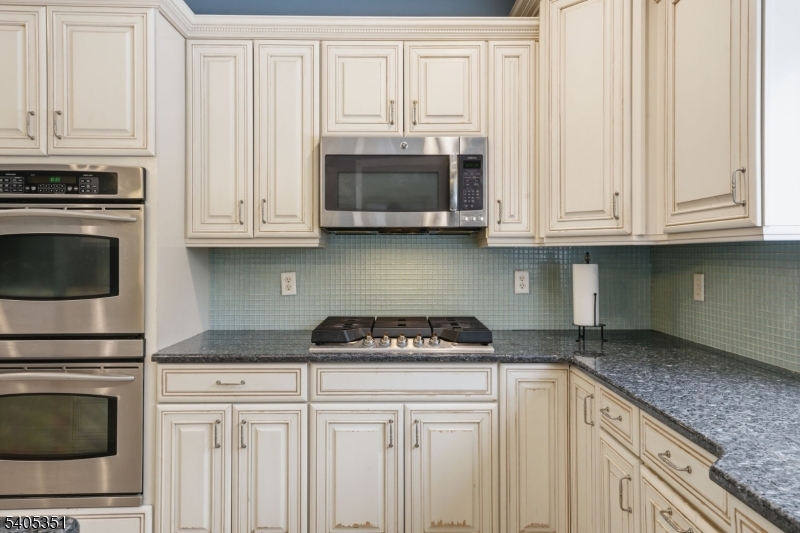 20 Sleepy Hollow Road Denville, NJ 07834 - Photo 18 of 48 a kitchen with granite countertop white cabinets and a stove