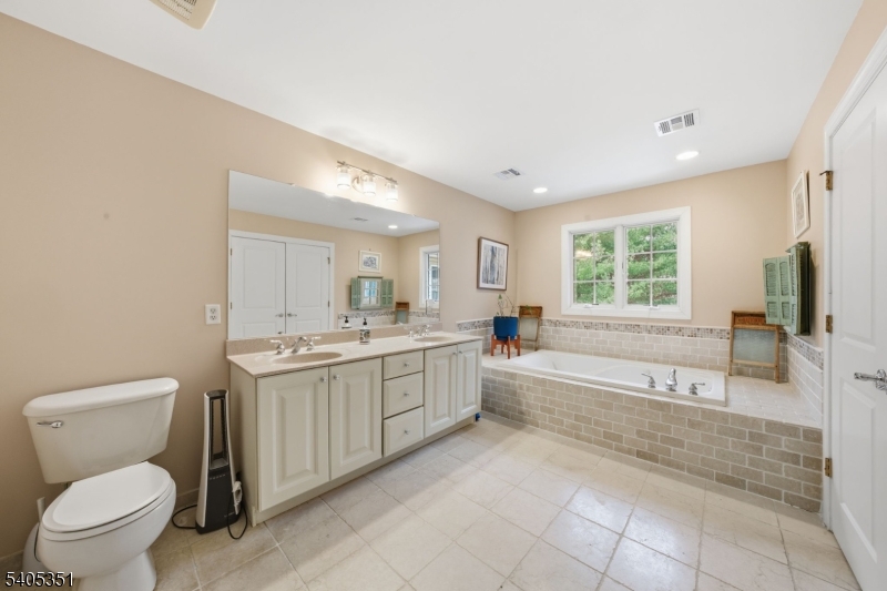 20 Sleepy Hollow Road Denville, NJ 07834 - Photo 29 of 48 a bathroom with a granite countertop toilet a sink and a bathtub