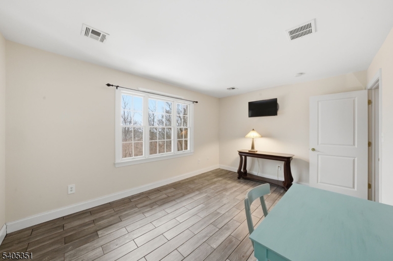20 Sleepy Hollow Road Denville, NJ 07834 - Photo 30 of 48 a bedroom with a bed table and a window