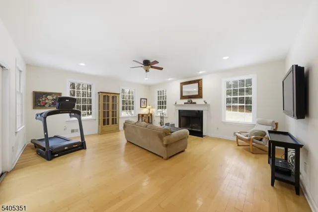 a living room with furniture flat screen tv and a fireplace