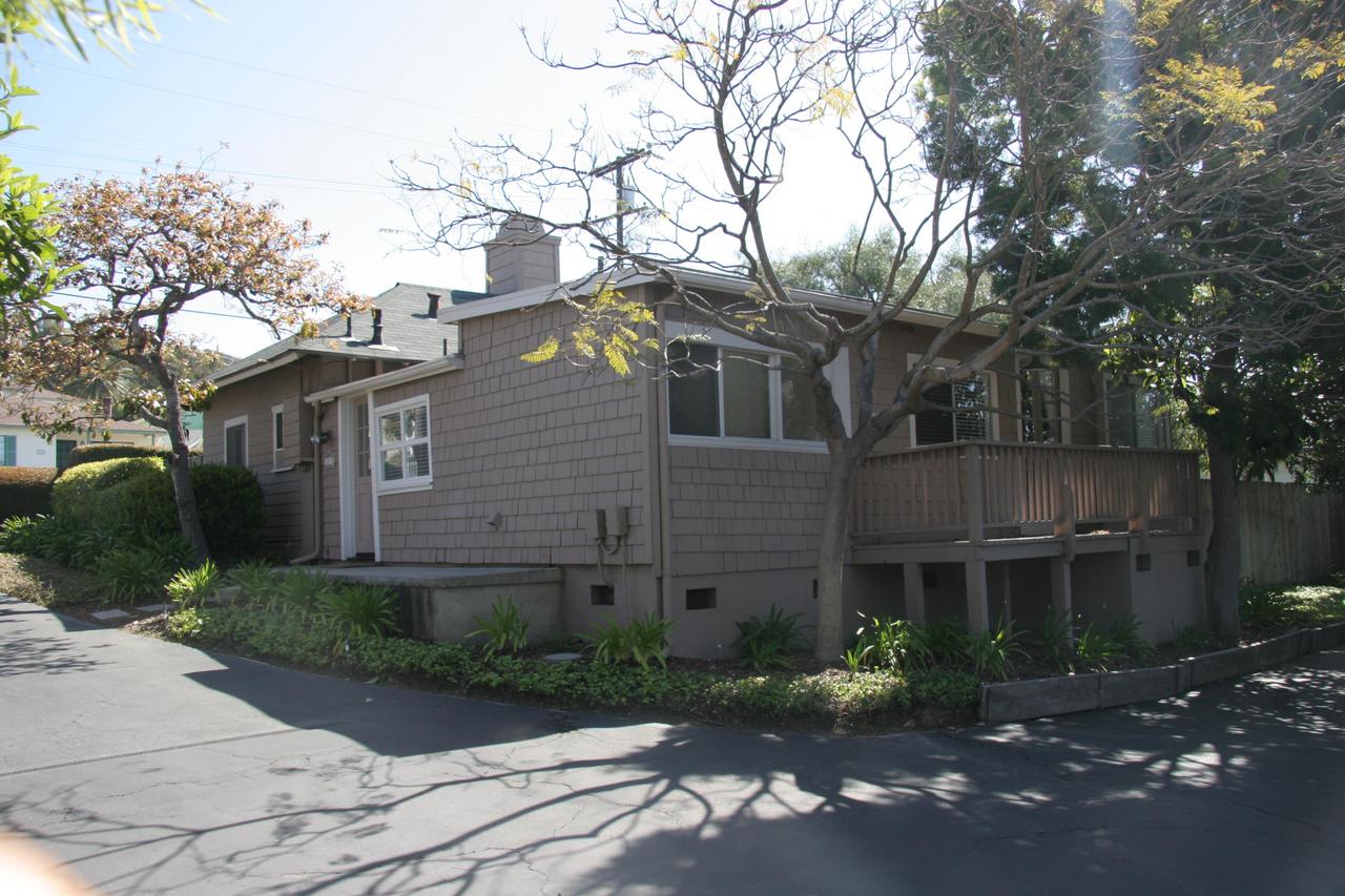30 South Salinas Street, Unit D Santa Barbara, CA 93103 - Photo 15 of 19 a view of a brick house next to a yard with potted plants