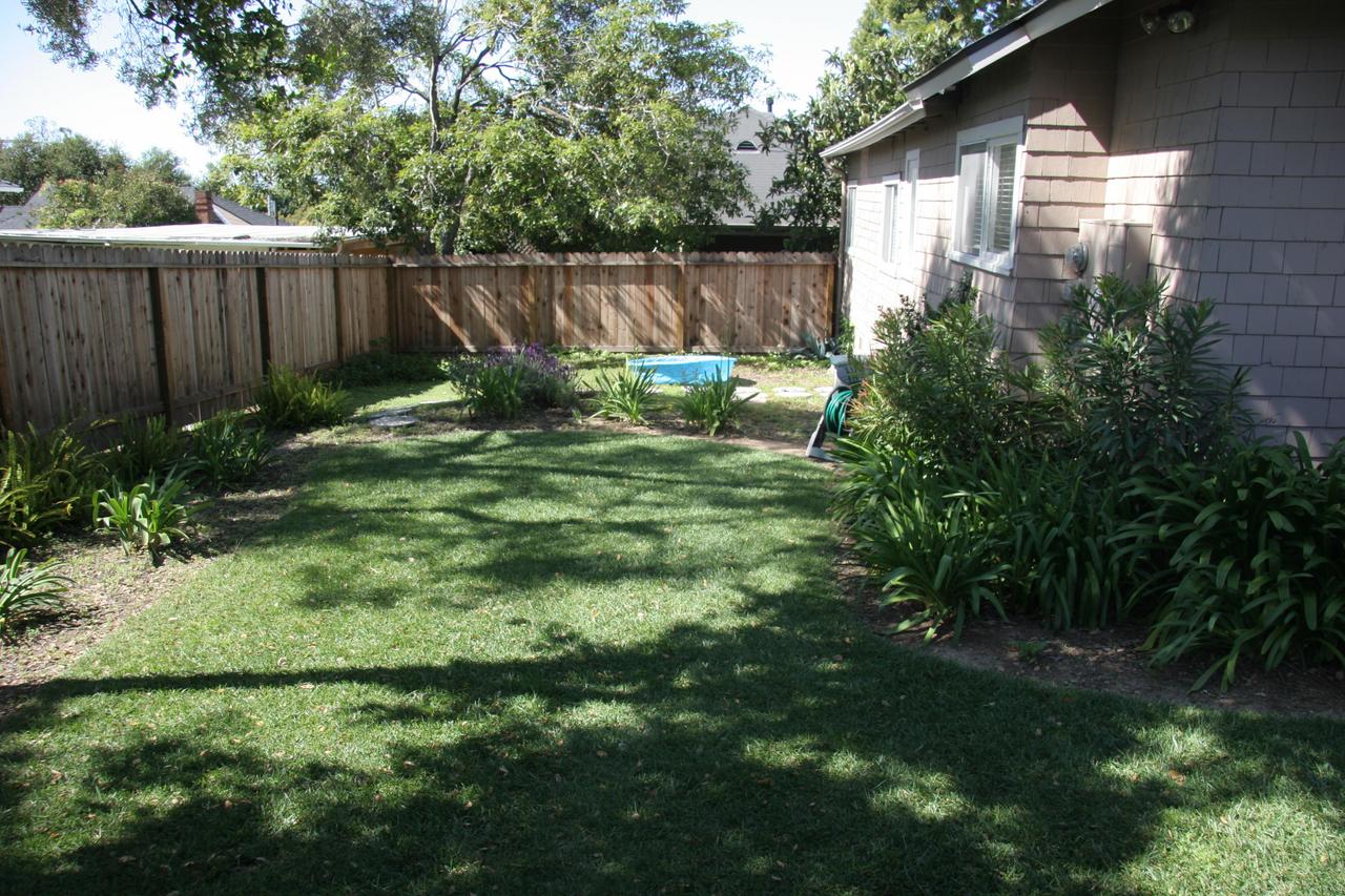 30 South Salinas Street, Unit D Santa Barbara, CA 93103 - Photo 3 of 19 a view of backyard with potted plants and wooden fence