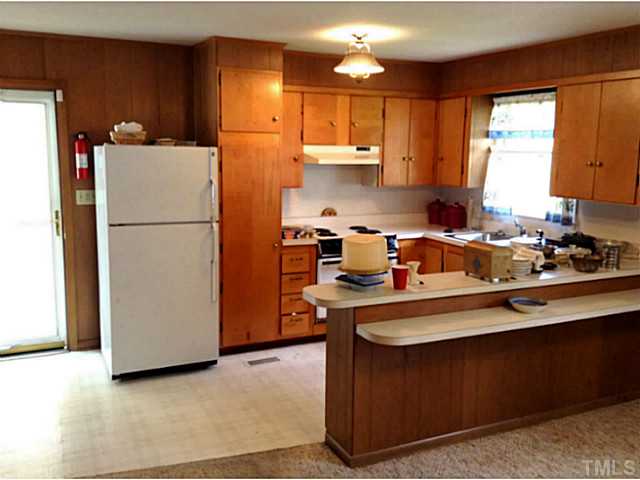 2405 Trawick Road Raleigh, NC 27604 - Photo 8 of 20 a kitchen with a refrigerator a stove a sink and a cabinets