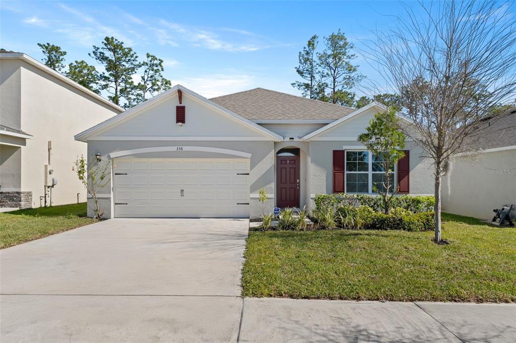 336 Camilla Road DeLand, FL 32724 - Photo 1 of 38 a front view of a house with garden