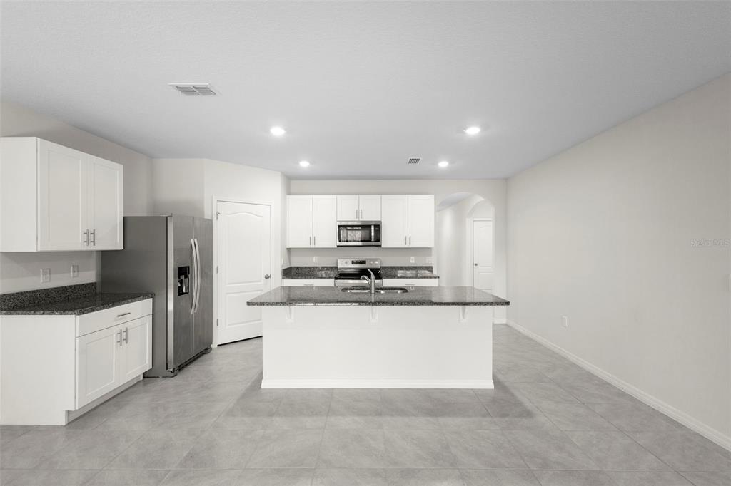 336 Camilla Road DeLand, FL 32724 - Photo 18 of 38 a kitchen with stainless steel appliances a sink stove and refrigerator