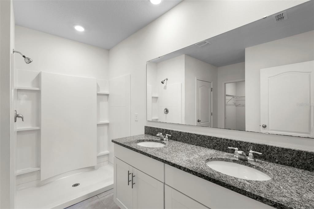 336 Camilla Road DeLand, FL 32724 - Photo 27 of 38 a bathroom with a granite countertop sink and a mirror