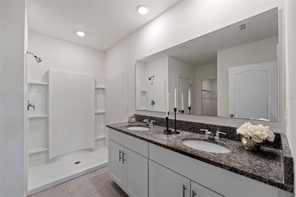336 Camilla Road DeLand, FL 32724 - Photo 28 of 38 a bathroom with a double vanity sink and shower