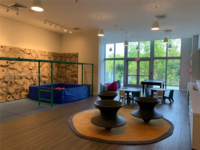 a living room with furniture and a floor to ceiling window