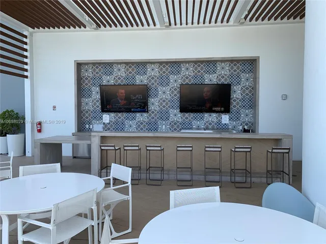a view of a patio with couches table and chairs and potted plants