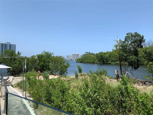 a view of swimming pool with outdoor seating and plants