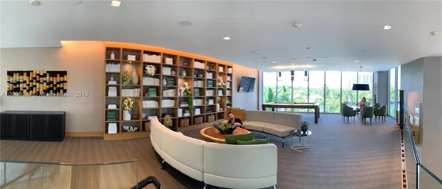 a lobby with furniture and a potted plant