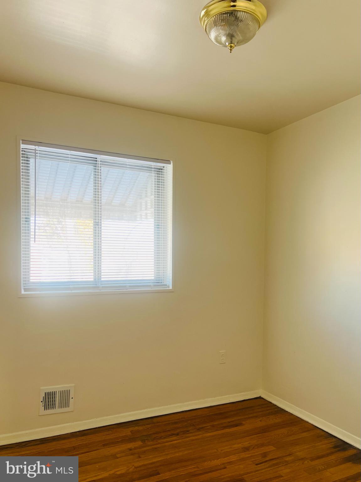 4901 Fitch Place Northeast Washington, DC 20019 - Photo 27 of 47 a view of a room with wooden floor and a window