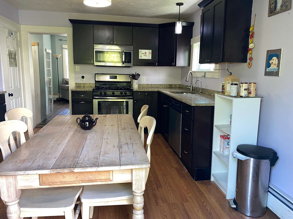 8 May Street Beverly, MA 01915 - Photo 10 of 25 a kitchen with kitchen island granite countertop wooden cabinets and a sink