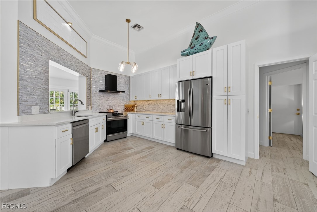 13570 Harbour Ridge Drive Fort Myers, FL 33908 - Photo 14 of 50 a kitchen with stainless steel appliances granite countertop a refrigerator a sink dishwasher a stove and white countertops with wooden floor