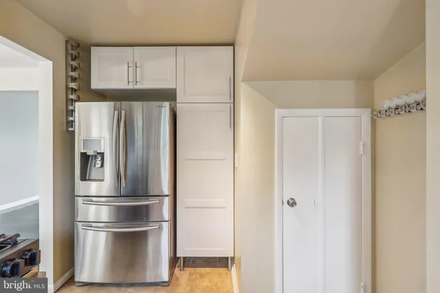 a metallic refrigerator freezer sitting in a kitchen