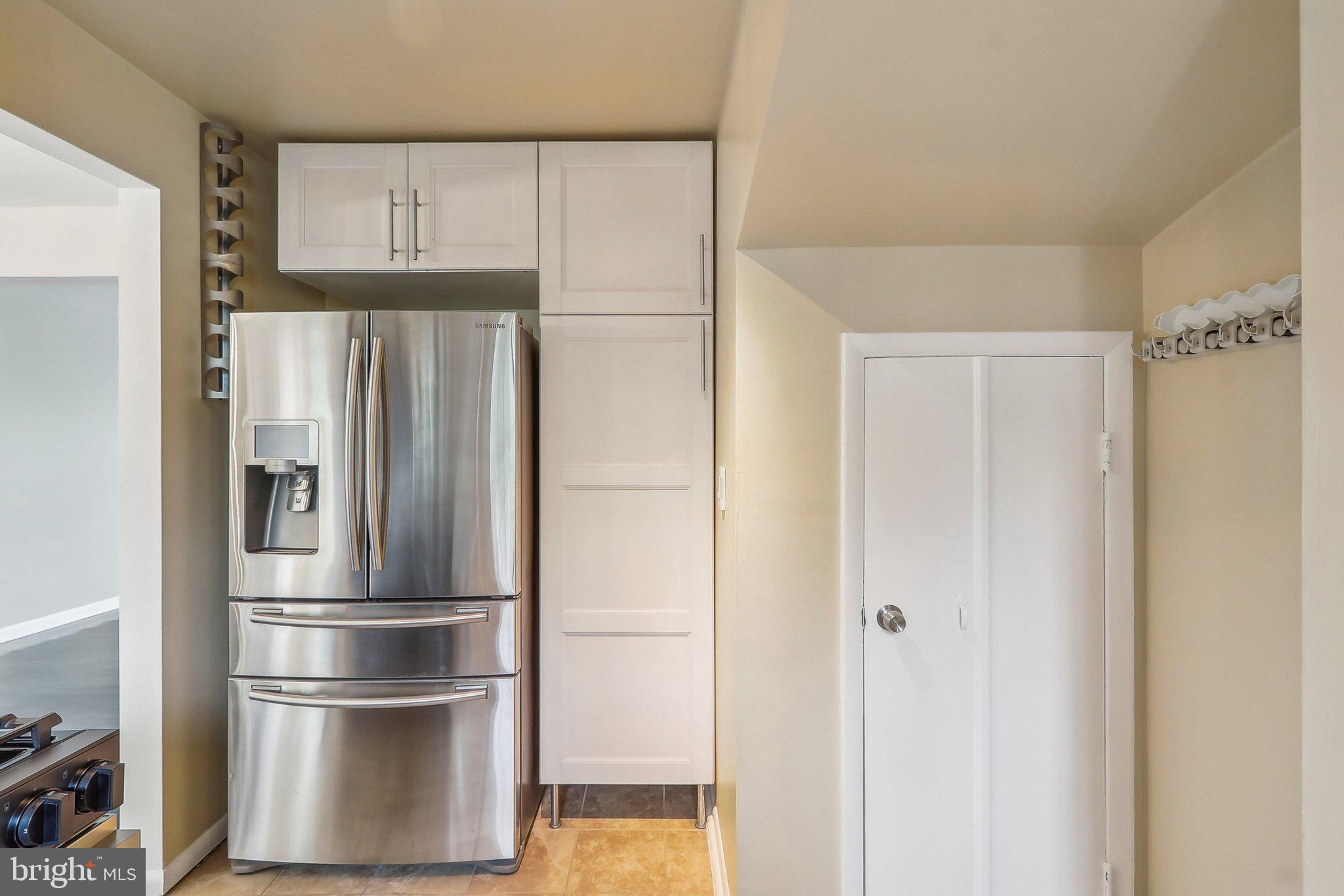 1360 W Street Northeast Washington, DC 20018 - Photo 14 of 48 a metallic refrigerator freezer sitting in a kitchen