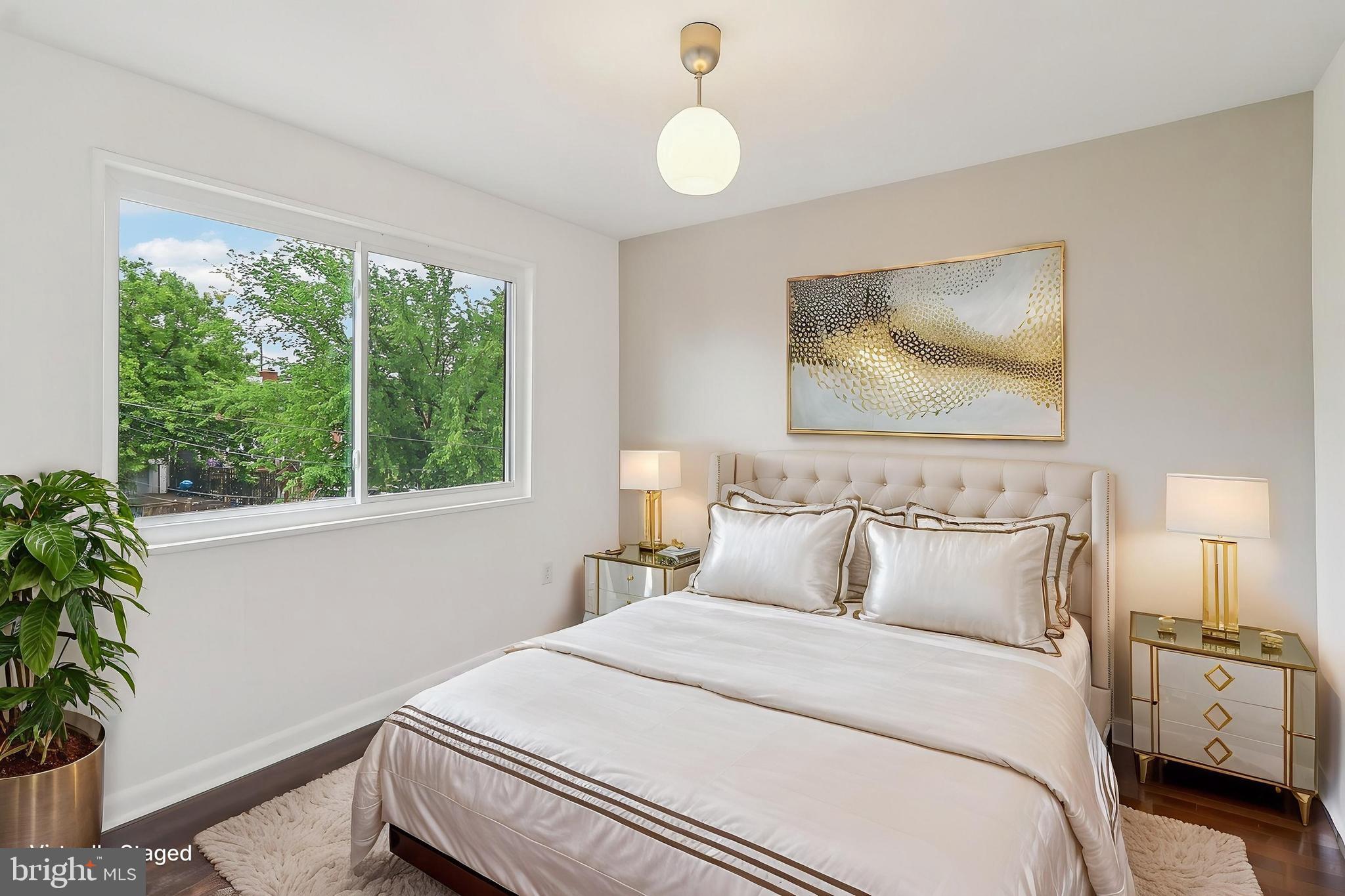 1360 W Street Northeast Washington, DC 20018 - Photo 21 of 48 a bedroom with a bed and a potted plant