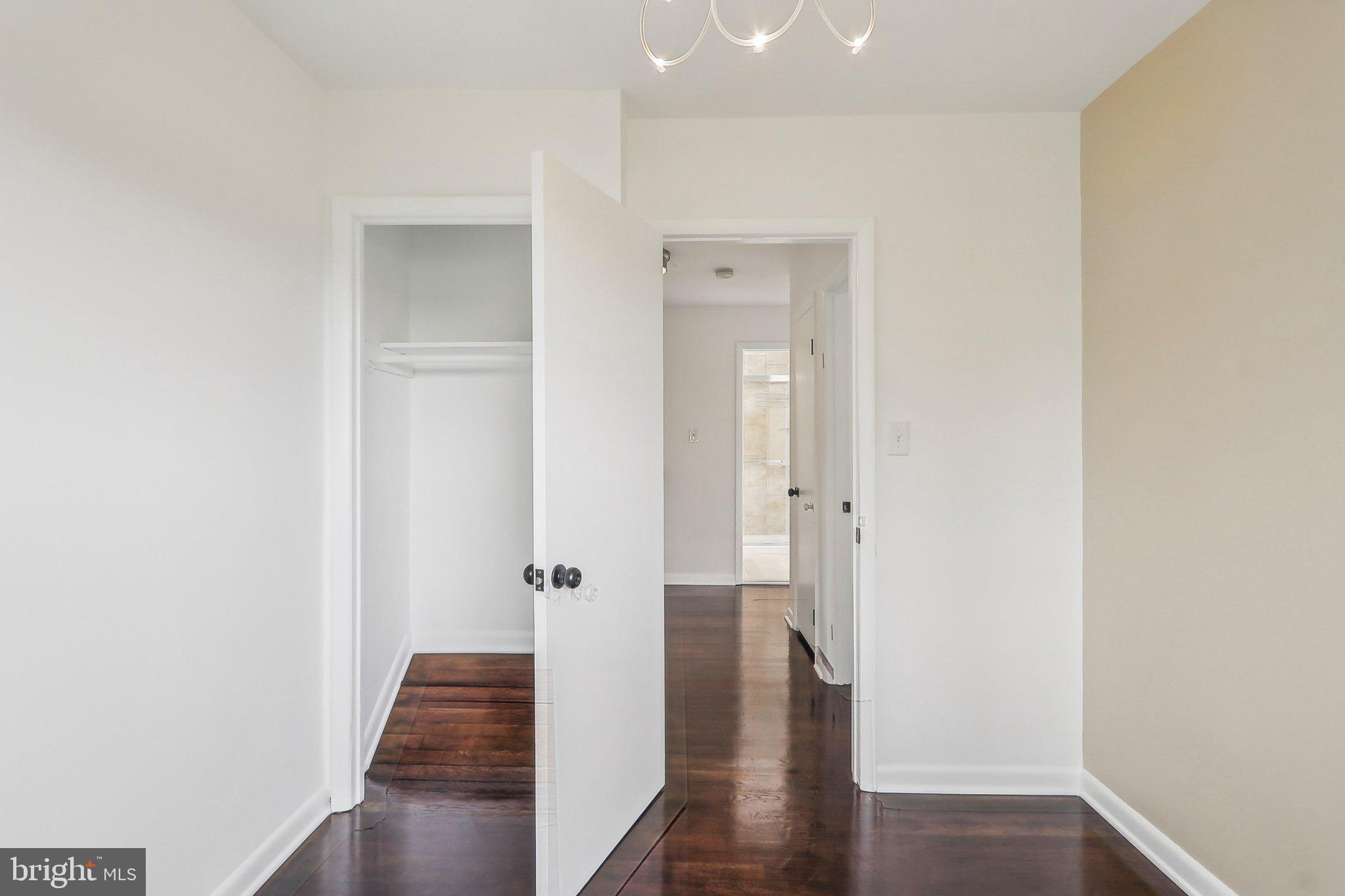 1360 W Street Northeast Washington, DC 20018 - Photo 26 of 48 a view of a hallway with wooden floor and closet