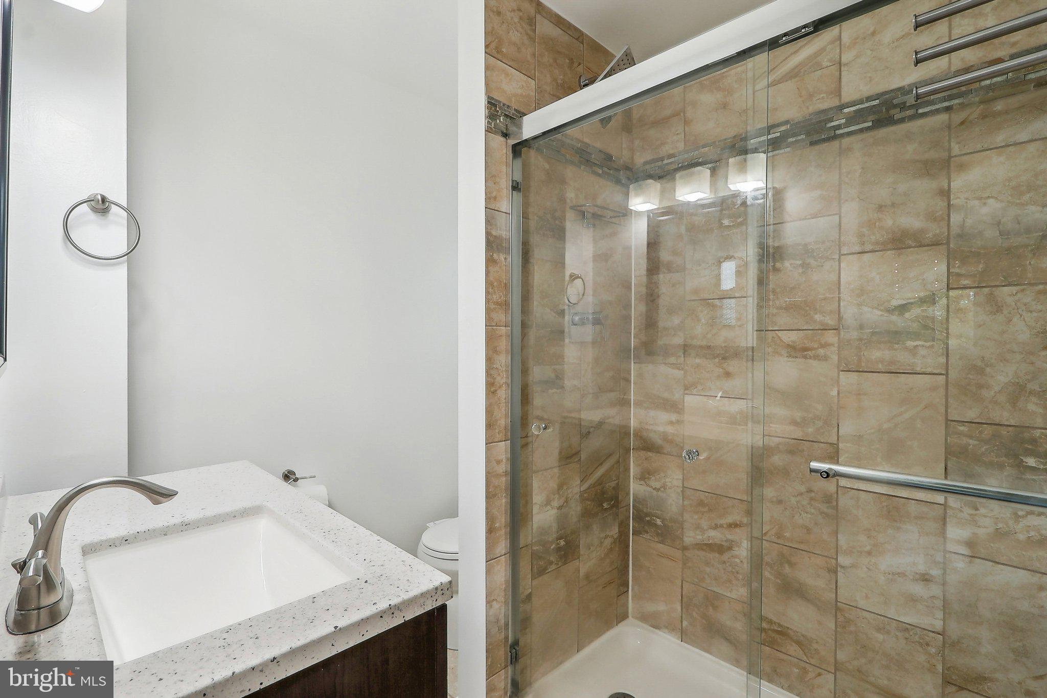 1360 W Street Northeast Washington, DC 20018 - Photo 27 of 48 a bathroom with a sink shower and a mirror