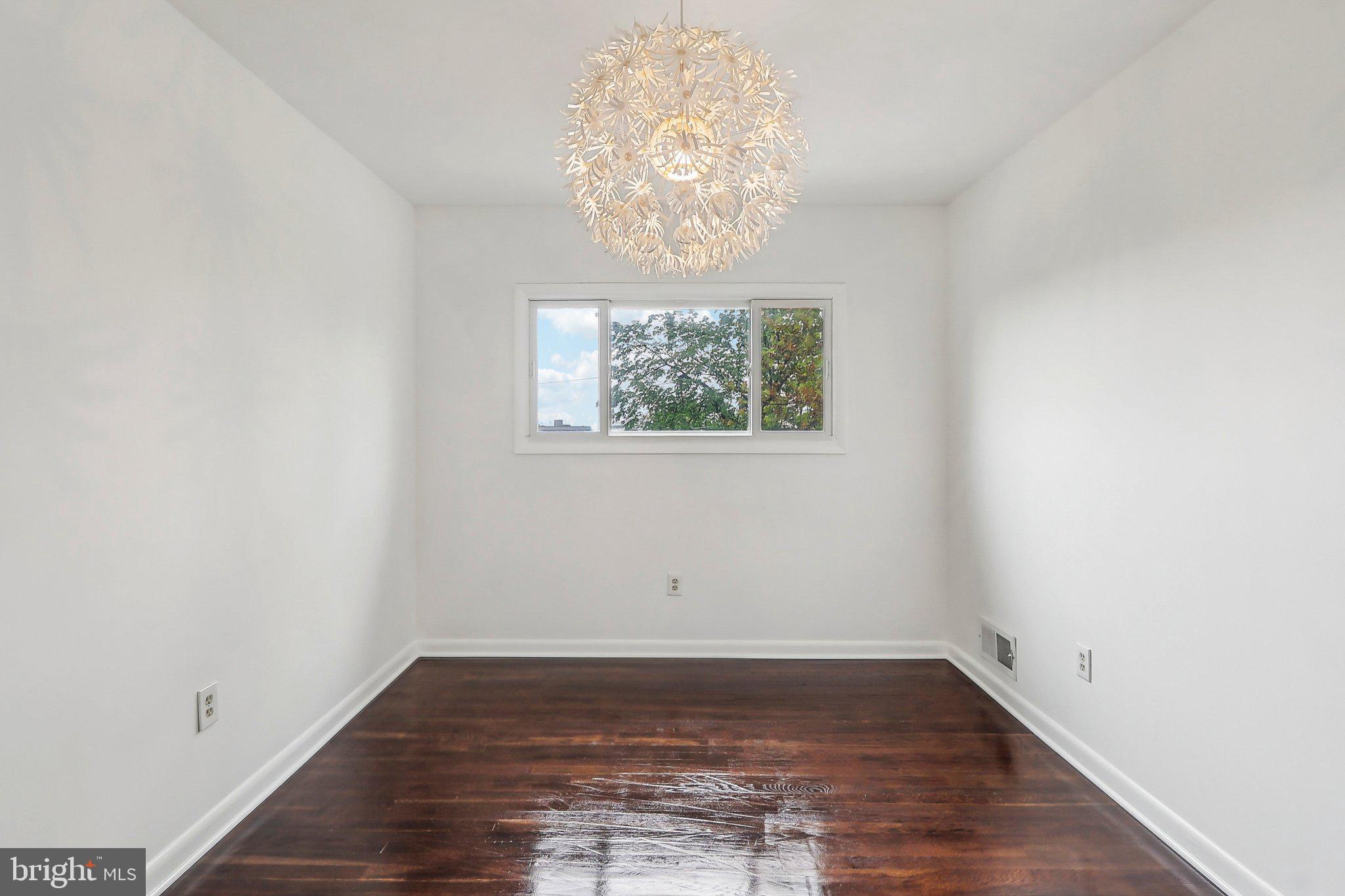 1360 W Street Northeast Washington, DC 20018 - Photo 29 of 48 an empty room with wooden floor and windows