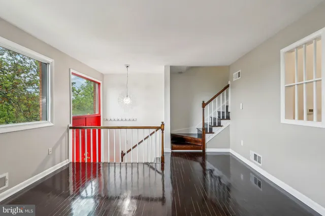 a view of entryway and hall with wooden floor
