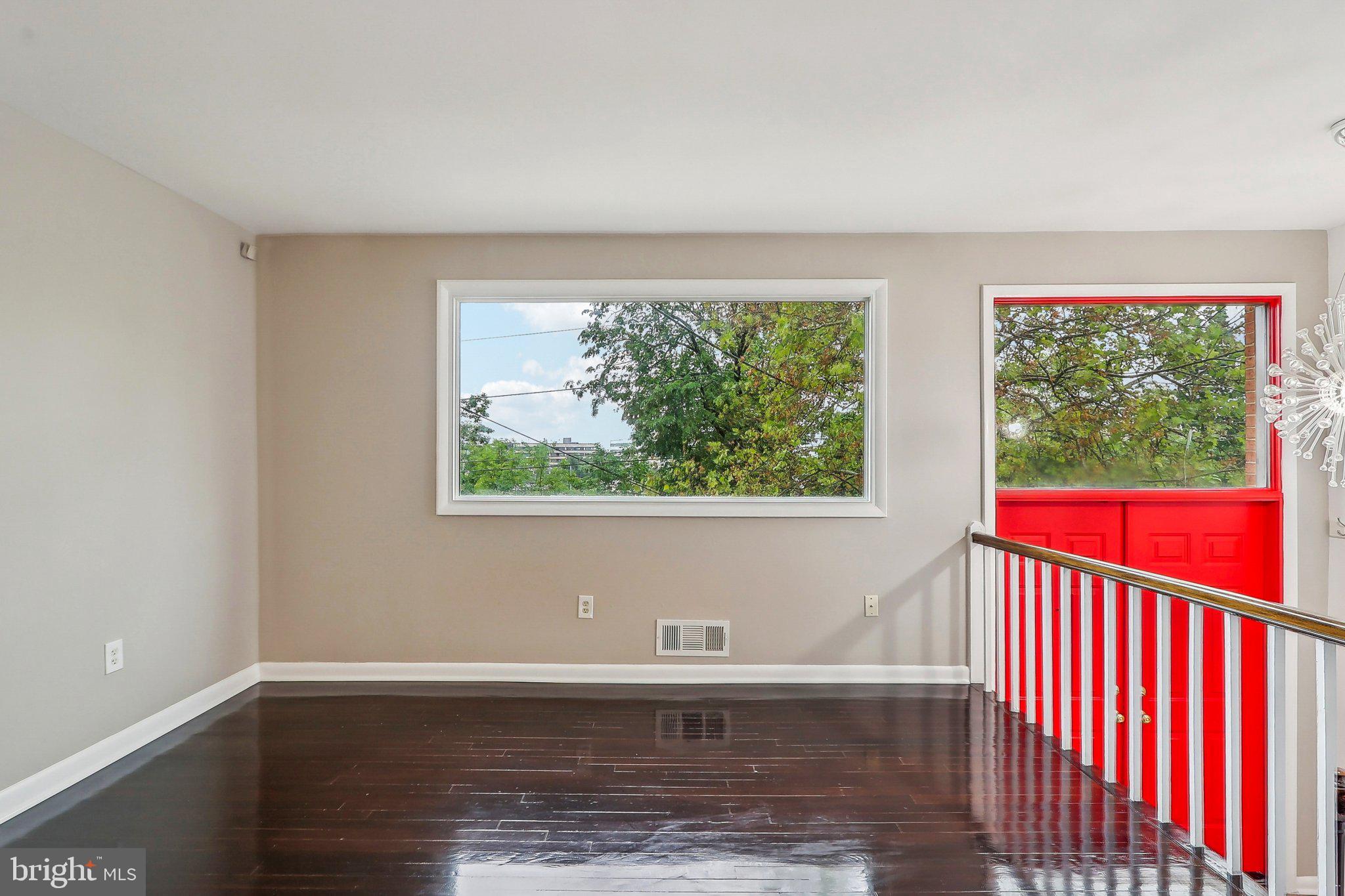 1360 W Street Northeast Washington, DC 20018 - Photo 4 of 48 a view of an empty room with wooden floor and a window