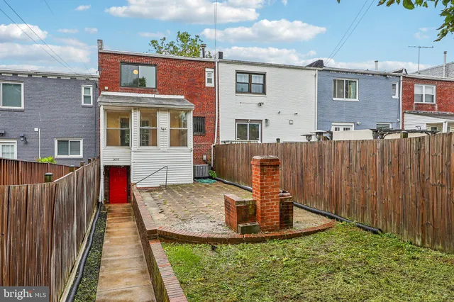 a view of a house with wooden fence