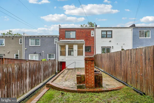 a view of a house with wooden fence
