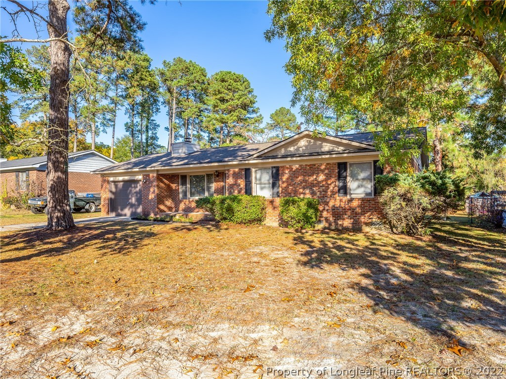 921 Hollydale Lane Fayetteville, NC 28314 - Photo 1 of 32 a view of a house with large tree and wooden fence