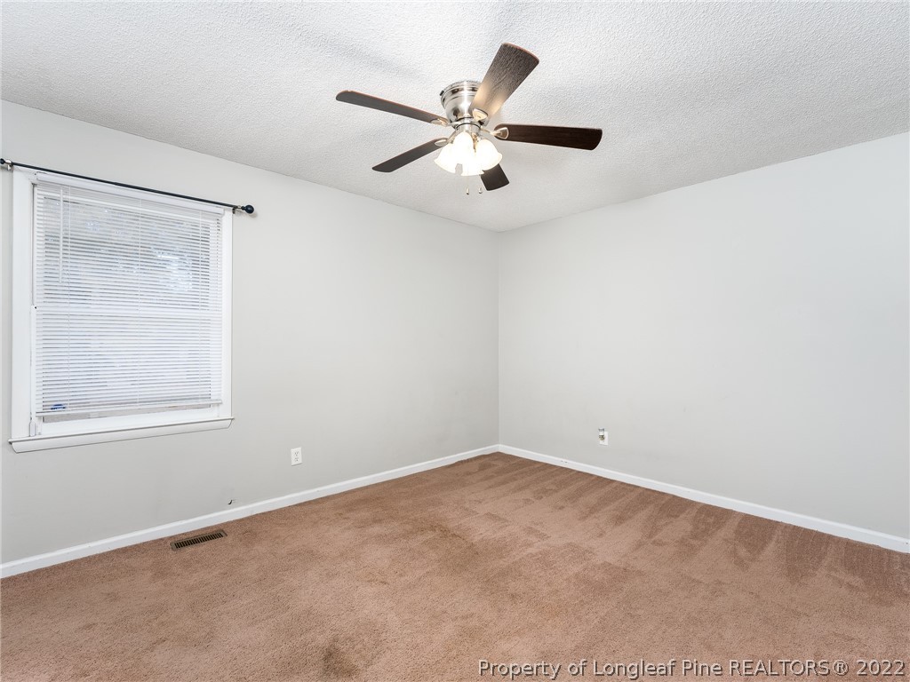 921 Hollydale Lane Fayetteville, NC 28314 - Photo 18 of 32 an empty room with a window and a fan