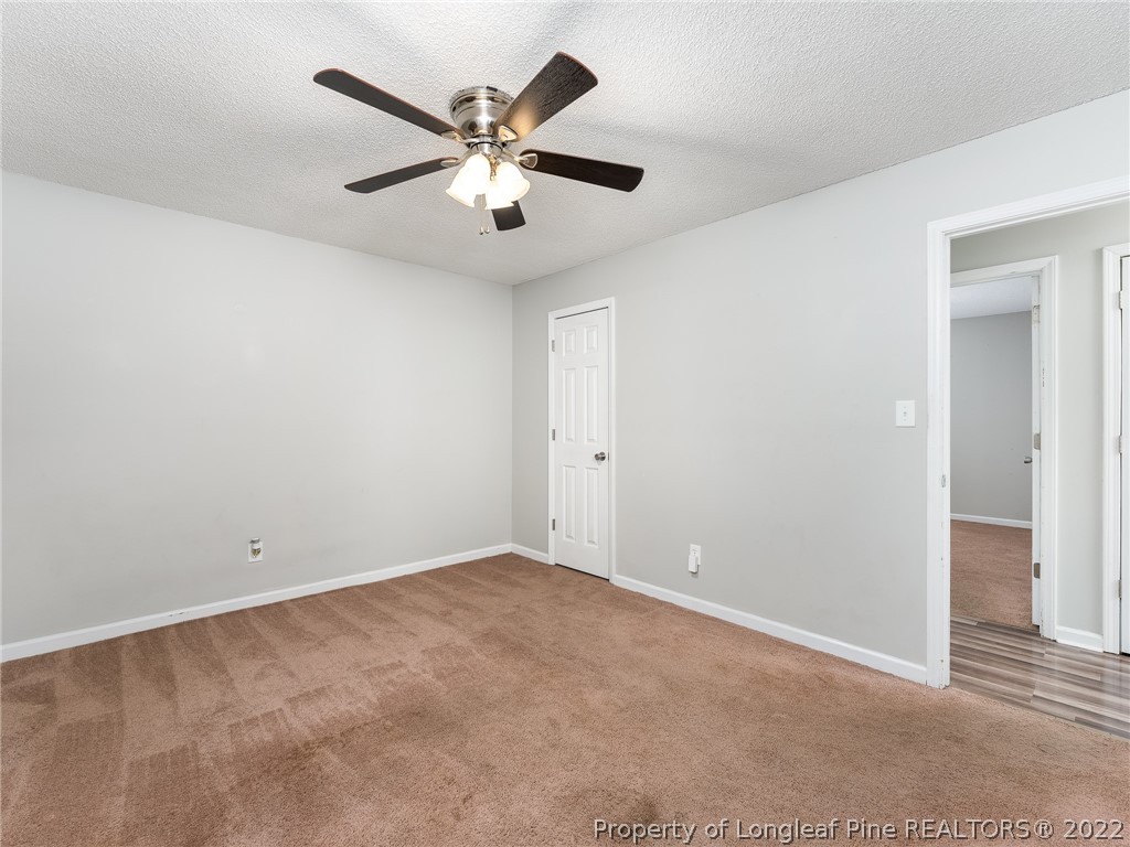 921 Hollydale Lane Fayetteville, NC 28314 - Photo 19 of 32 an empty room with closet and a chandelier fan