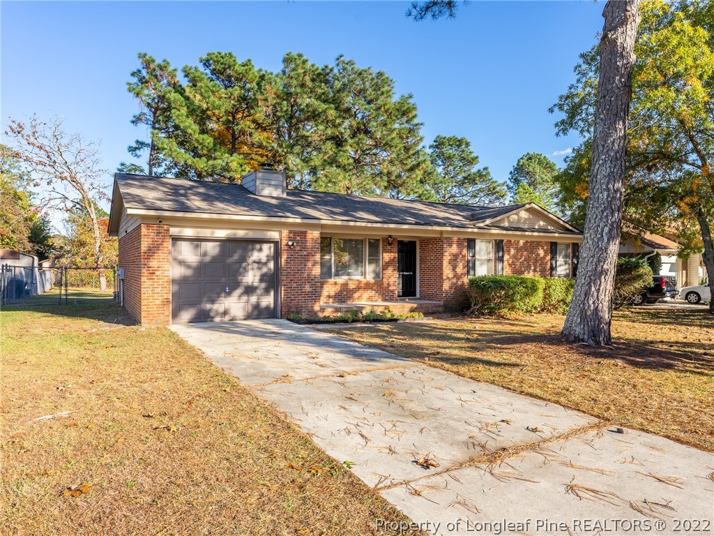 921 Hollydale Lane Fayetteville, NC 28314 - Photo 2 of 32 a front view of a house with a yard and garage