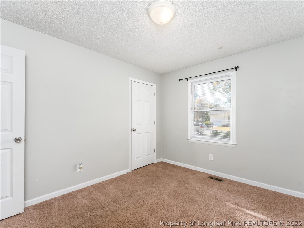 921 Hollydale Lane Fayetteville, NC 28314 - Photo 23 of 32 an empty room with windows