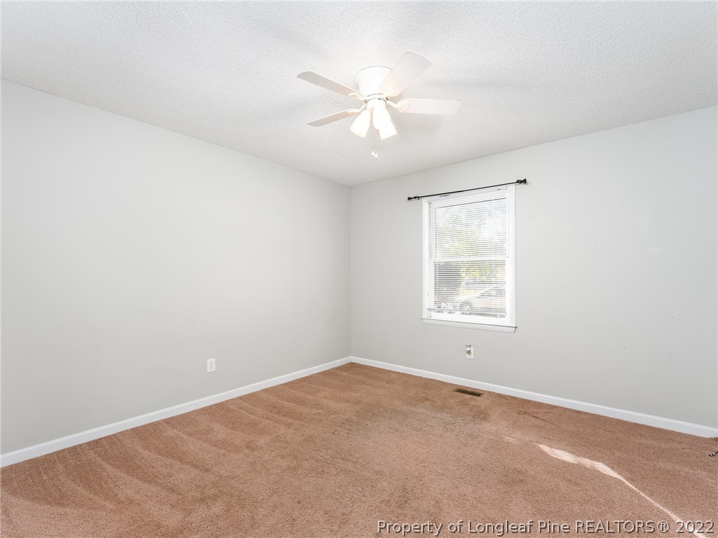 921 Hollydale Lane Fayetteville, NC 28314 - Photo 25 of 32 an empty room with a window and a fan