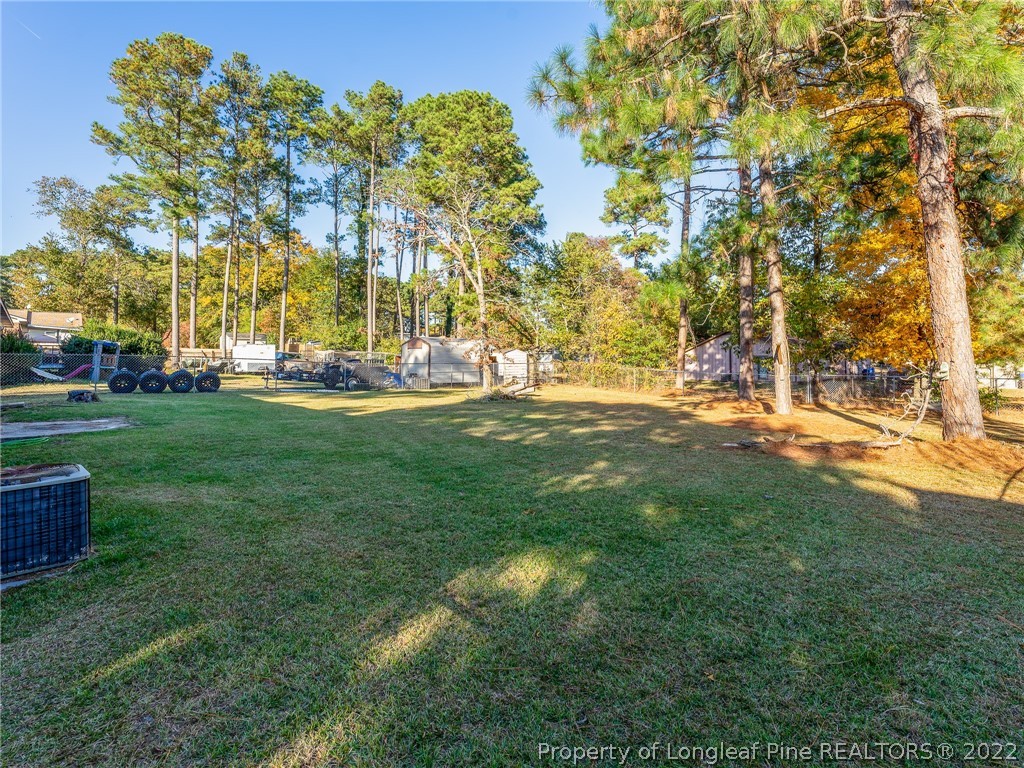 921 Hollydale Lane Fayetteville, NC 28314 - Photo 31 of 32 a view of yard with swimming pool and green space