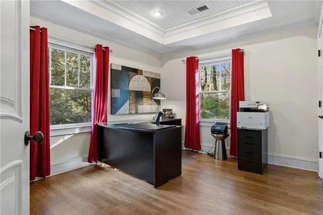 a bedroom with a large bed and a potted plant