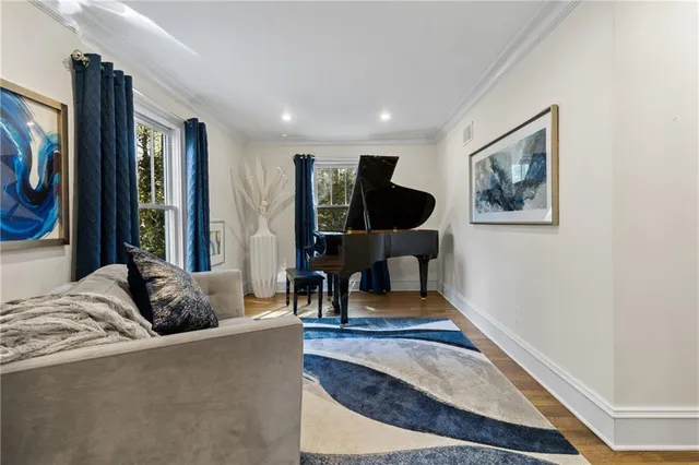a view of a hallway with bathroom and wooden floor