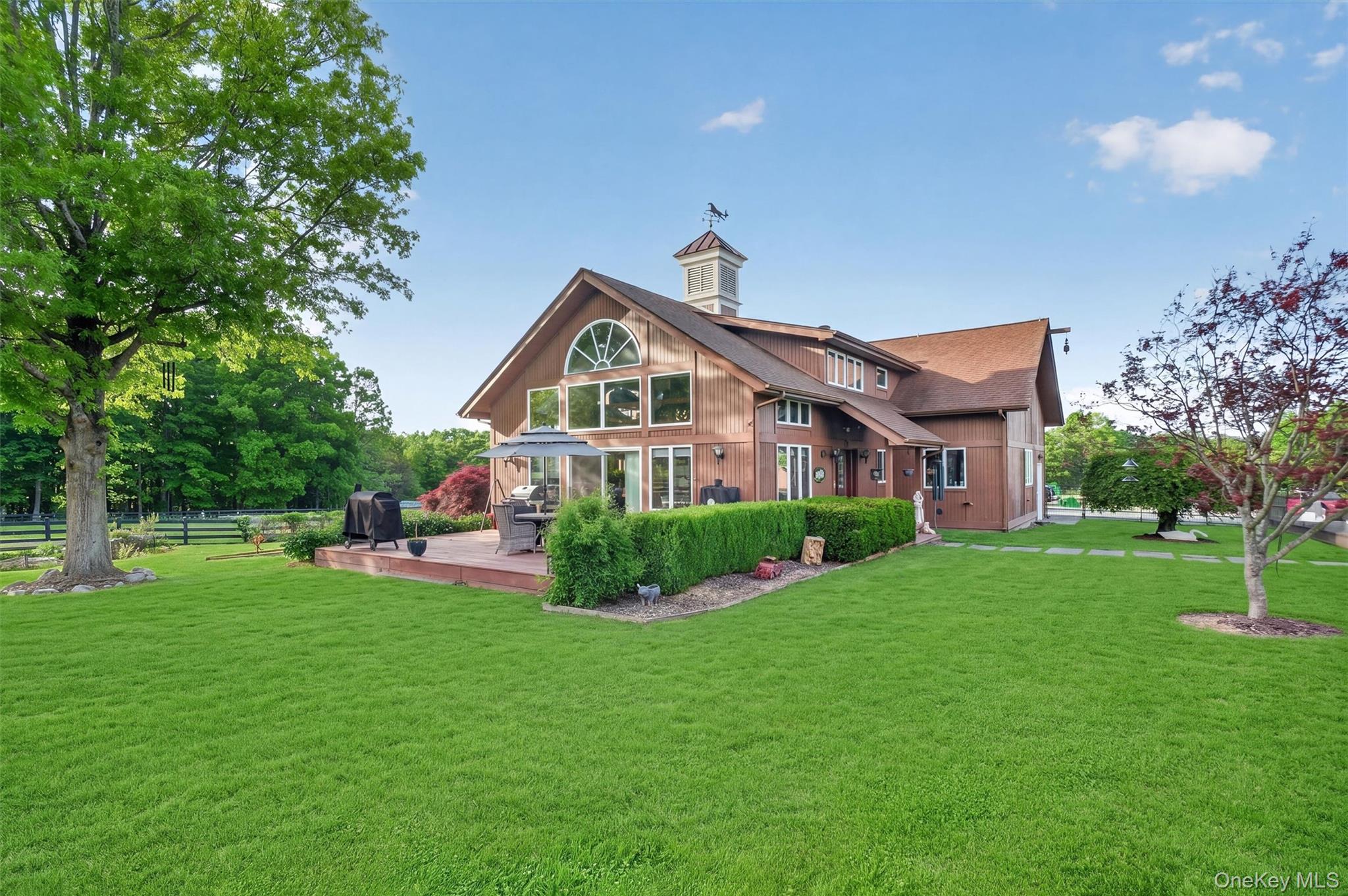 165 Hasbrouck Road Goshen, NY 10924 - Photo 38 of 50 2nd home features a wall of windows to take in the views, a low deck for outdoor entertainment and an expansive lawn with koi pond