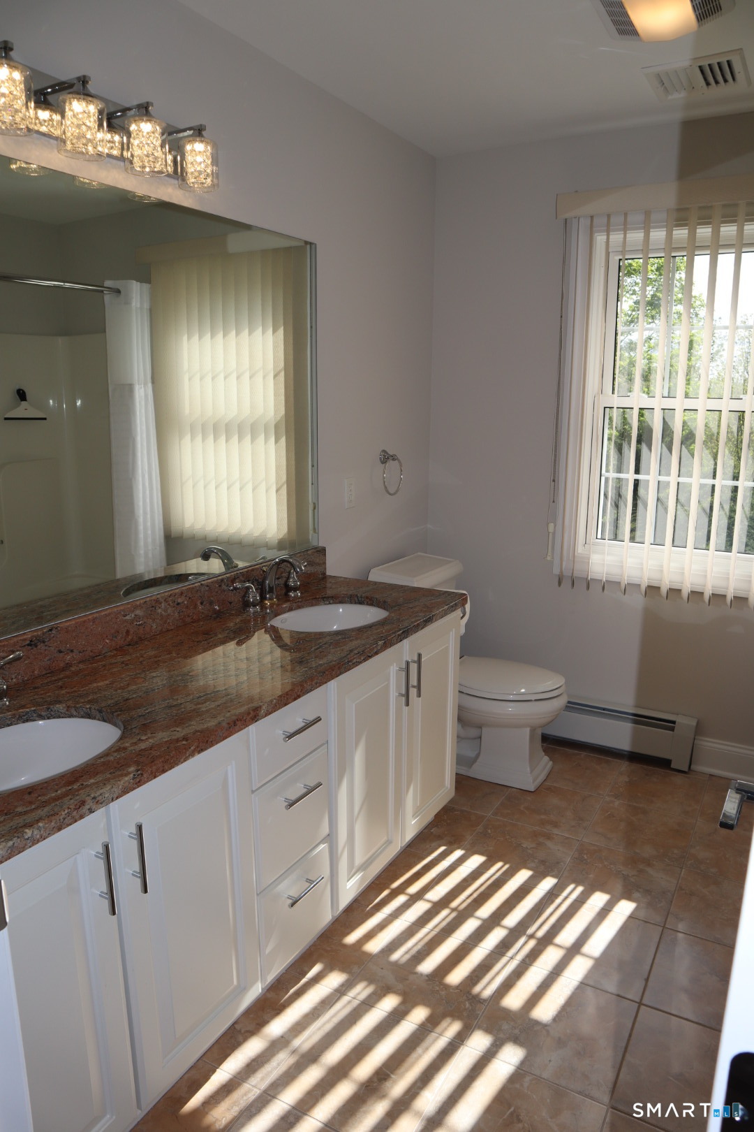 51 Brookfield Road Seymour, CT 06483 - Photo 32 of 37 a spacious bathroom with a granite countertop sink a toilet and a window