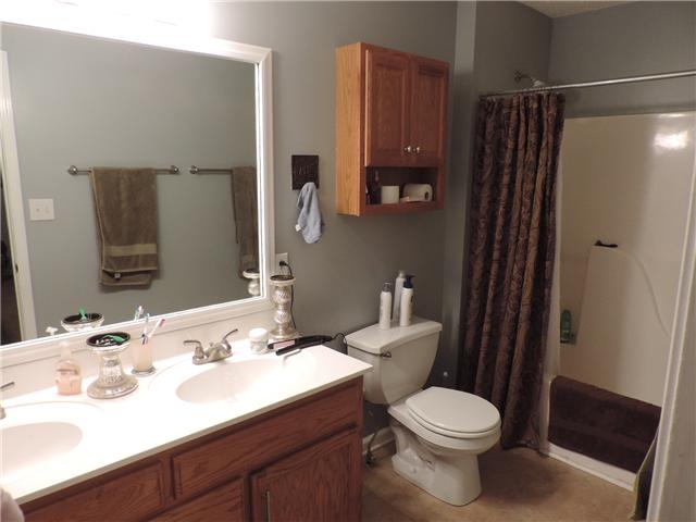 3480 Trough Springs Road Adams, TN 37010 - Photo 14 of 17 Master bath with double vanities, tile floors, and tub/shower combo.