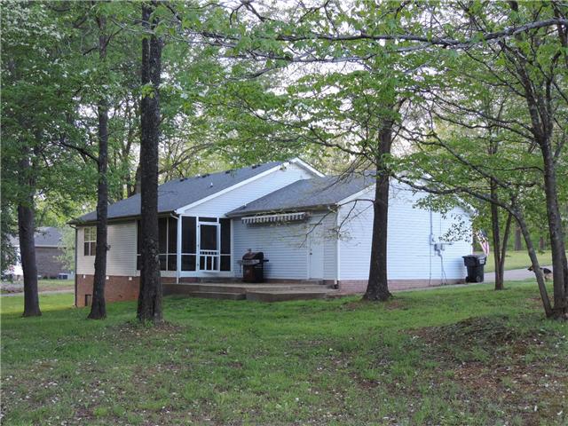 3480 Trough Springs Road Adams, TN 37010 - Photo 4 of 17 Pedestrian door from garage; screened in back porch, retractable awning over concrete patio.