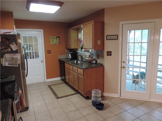 3480 Trough Springs Road Adams, TN 37010 - Photo 10 of 17 Sink area of kitchen overlooks screened in back porch and back yard. All appliances are stainless, except dishwasher - refrigerator stays.