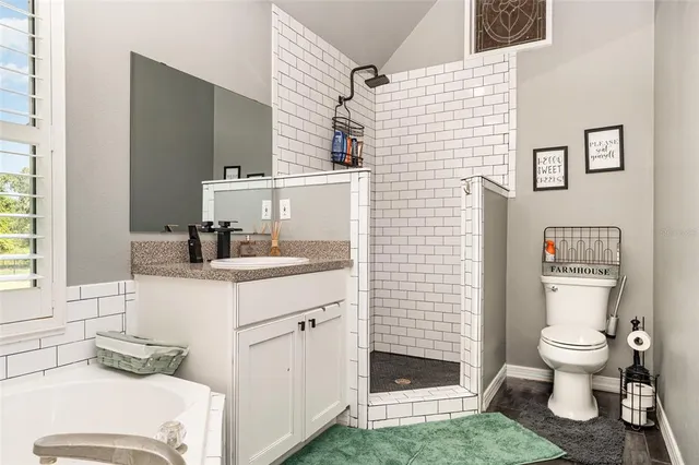 a bathroom with a sink toilet and shower