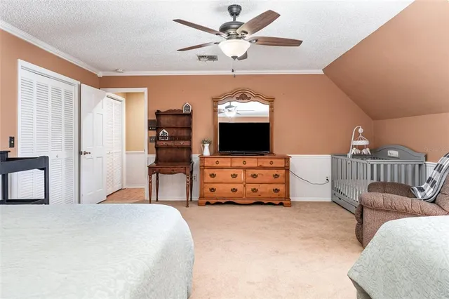 a bedroom with furniture and a flat tv screen